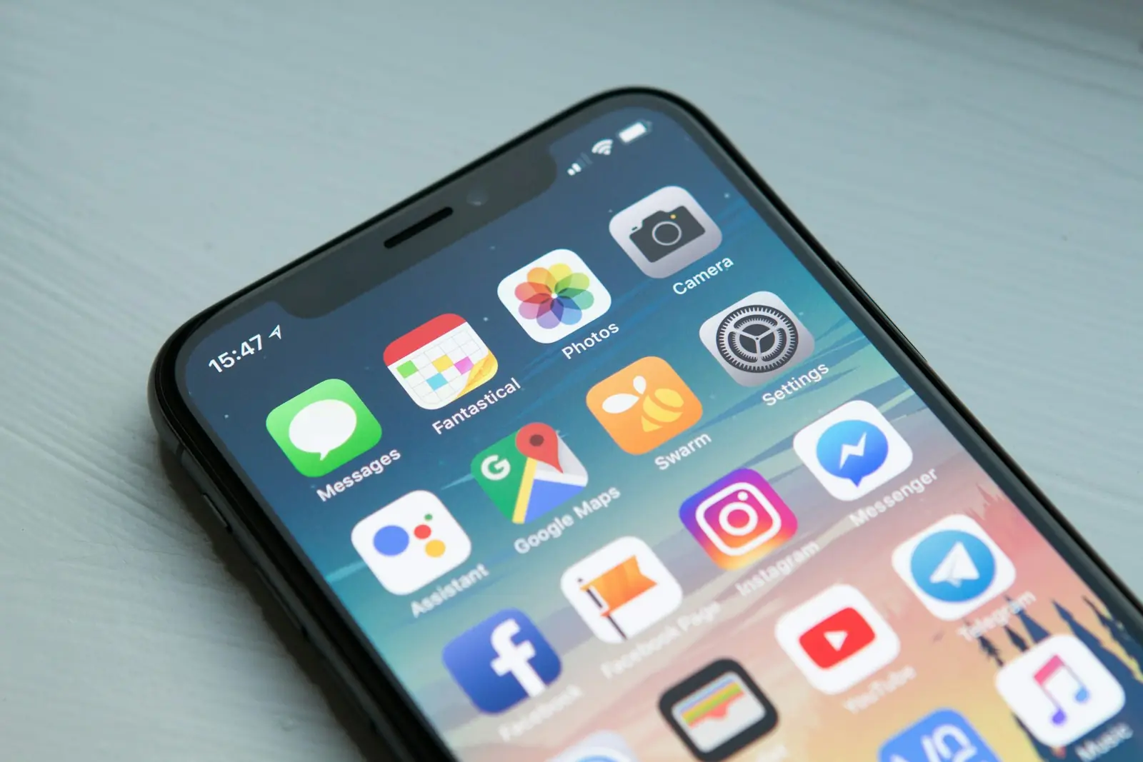 Smartphone home screen showing rows of app icons