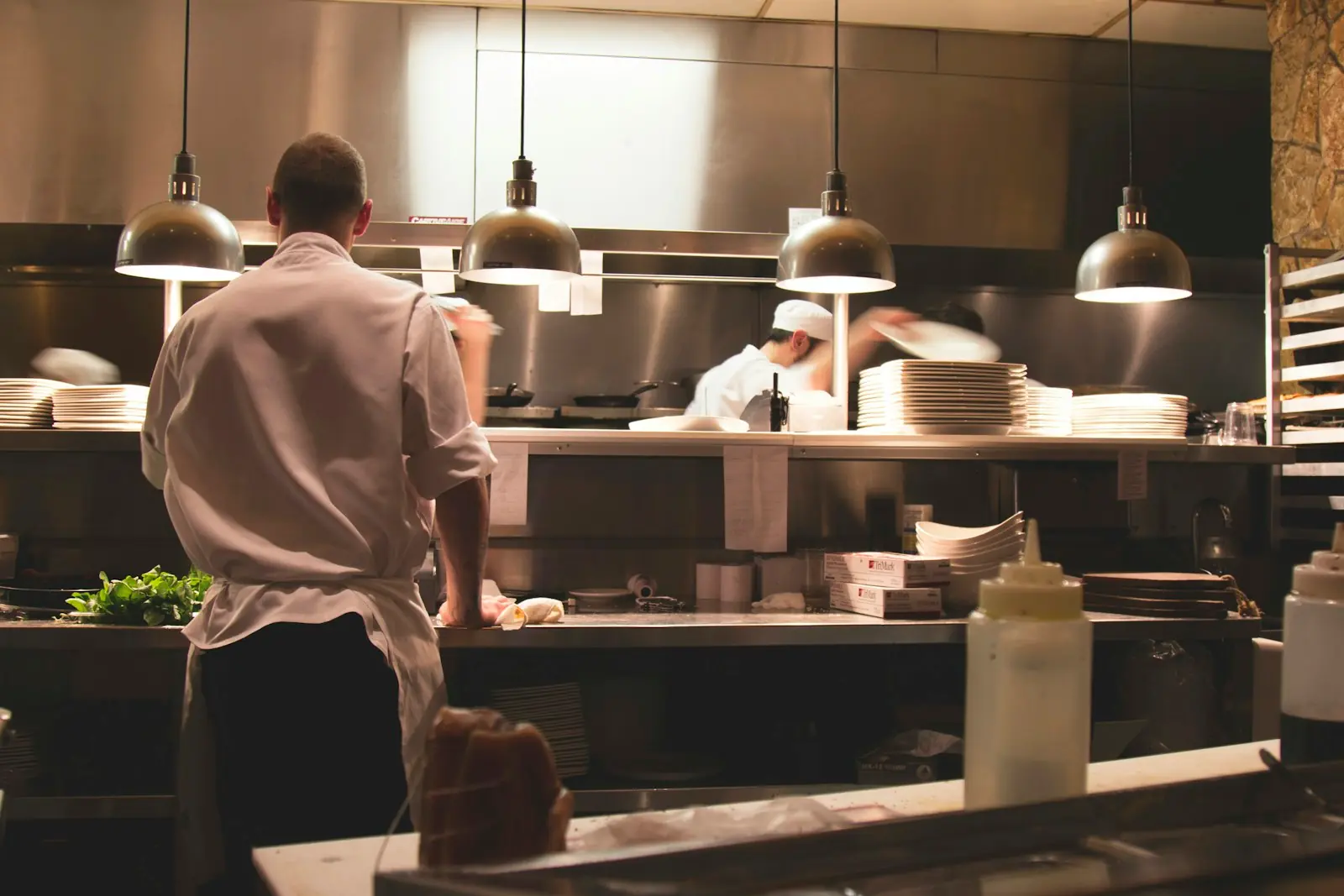 Chef preparing food on a clean kitchen line